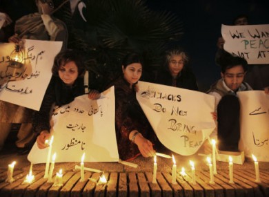 Pakistanis in Islamabad light candles during a protest to condemn the soldiers' killing.