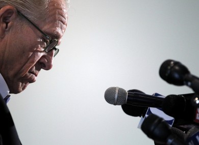 Attorney Jeff Anderson looks down as he reads a statement from his client during a news conference