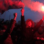 Protesters light flares during the rally (AP Photo/Sergey Ponomarev)