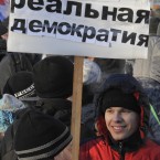 A demonstrator holds a poster reading