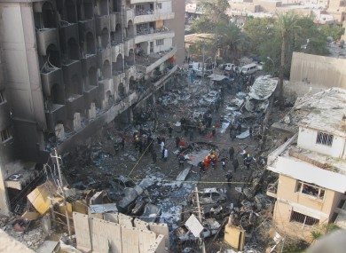 Iraqi security forces gather the scene of a car bomb attack in Baghdad.