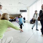 Dylan Horwitz, 8, from Fairfield, Connecticut, sprints into the arms of her grandparents, Gwen Asher and Ken Asher at Southwest Florida International.
(AP Photo/Naples Daily News, Tristan Spinski) 
