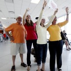 George Poli, Paige Kinstler, Connie Kinstler, and Jill Kinstler wear Santa hats as they prepare to greet Cynthia Smith at Southwest Florida International.
(AP Photo/Naples Daily News, Tristan Spinski
