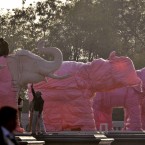 Indian workers cover elephant statues at Ambedkar Park in Noida, on the outskirts of New Delhi. (AP Photo/Tsering Topgyal)