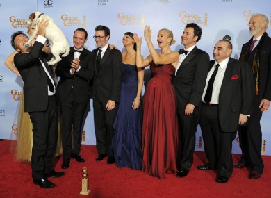 Uggie the dog joins other crew and cast members from The Artist to celebrate last night's award wins.