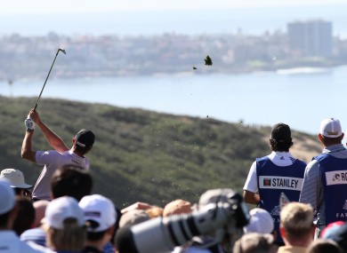 Kyle Stanley sends his divot flying as he hits a tee shot during the final round of the Farmers Insurance Open.