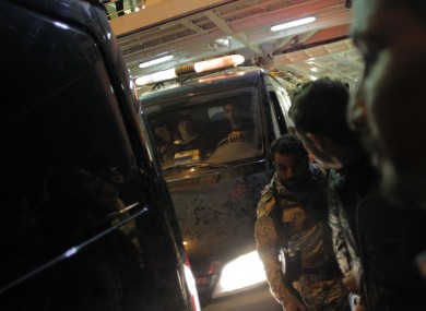 Vans carrying the bodies of photographers Tim Hetherington and Chris Hondros, killed in Libya in April 2011