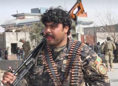 An Afghan security officer at the schene of today's car bomb explosion in Kandahar.