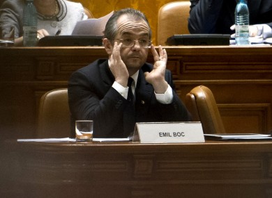 Emil Boc adjusts his glasses at the Romanian parliament in Bucharest last month.