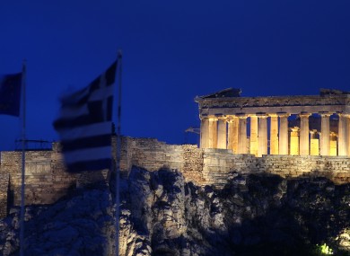 The Greek and EU flags fly in Athens yesterday