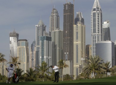 McIlroy takes a shot on the 13th hole of the Dubai Desert Classic today.