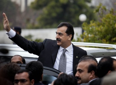 Pakistani Prime Minister Yousuf Raza Gilani waves upon his arrival at the Supreme Court for a hearing in Islamabad, Pakistan today