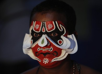 An Indian Kathakali dancer prepares for a performance in Hyderabad today.