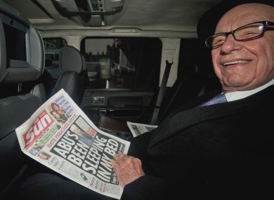 Rupert Murdoch reading The Sun in the back of a car on Friday afternoon