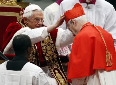 Newly-elected Cardinal Karl Becker, of Germany, receives his biretta hat from Pope Benedict XVI.