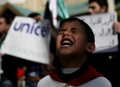 A Syrian boy chants slogans during a rally demanding UNICEF to protect Syrian children in front of the UNICEF Compound in Amman, Jordan