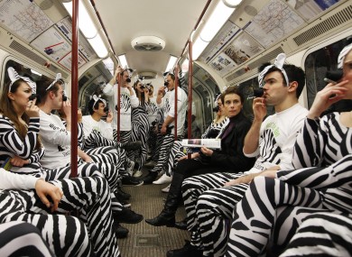 People dressed as zebras 'smoke' on the London Underground to promote the launch of the Zebra Electric Cigarette.
