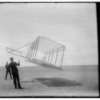 1901: A glider aircraft flying as a kite near the ground with Wilbur on the left and Orville on the right. (Library of Congress, Prints & Photographs Division)
