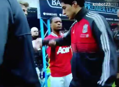 Suarez refuses to shake Evra's hand.