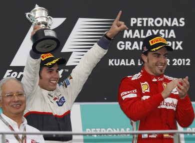 Sergio Perez (left) and Fernando Alonso celebrate.