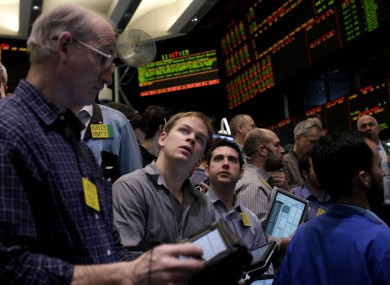 Traders work in the energy options pit at the New York Mercantile Exchange in New York yesterday as the price of oil reached its highest since July 2008.