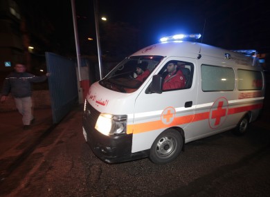 A Lebanese Red Cross ambulance follows Lebanese police vehicles carrying two injured French journalists who were trapped at Baba Amr neighborhood in Homs province
