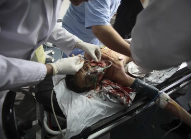 Palestinian medics treat a wounded person at Shifa hospital following an Israeli air strike, in Gaza City, Monday, March 12, 2012