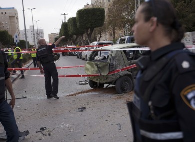 Israeli police officers after a rocket fired from the Gaza Strip hit the city of Ashdod in southern Israel earlier today