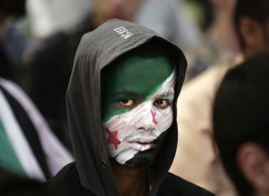 A Yemeni boy attends a ceremony making the anniversary of the Syrian revolution in Sanaa, Yemen.