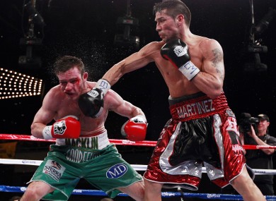 Martinez (right) throws a punch.