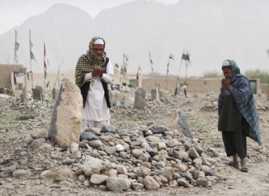 Praying at the grave of one of the victims of the shooting rampage.