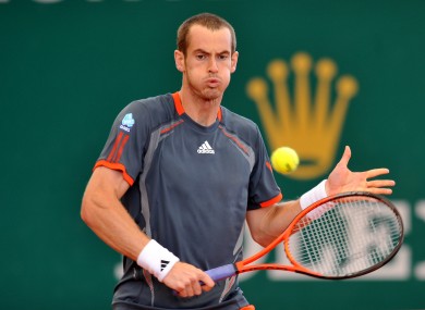 Andy Murray plays a shot at the net during his third round clash
