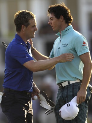 Luke Donald and Rory McIlroy compare notes at the Dubai World Championship in 2011
