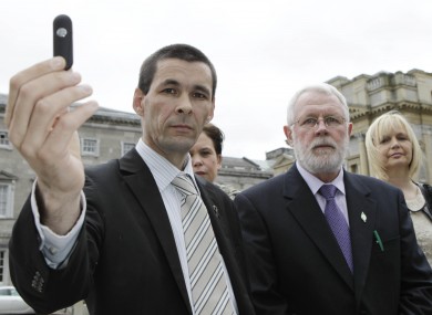 Sinn Féin's Jonathan O'Brien, on 5 April 2011, holds memory stick which was said to contain the audio of gardai joking about rape and deportation in relation to Corrib protestors.