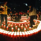 People use candles to create the number 60, representing the minutes in an hour, to mark Earth Hour in La Paz, Bolivia. (AP Photo/Juan Karita)
