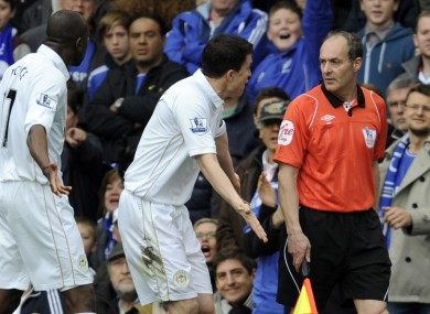 Wigan players protest after Chelsea's opening goal.