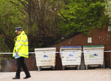 A Hampshire Police officer stands guard at the scene in Southampton where a burnt body was discovered in an industrial bin by firemen.