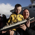 Scully, 6, holding a model of the Titanic, poses for pictures with Lload Walsh, as they wait to greet the disembarking passengers of the MS Balmoral Titanic memorial cruise ship at its first stop in Cobh (AP Photo/Lefteris Pitarakis)