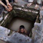 A Pakistani boy swims in a water reservoir to cool off as the temperature rises. (AP Photo/Muhammed Muheisen)