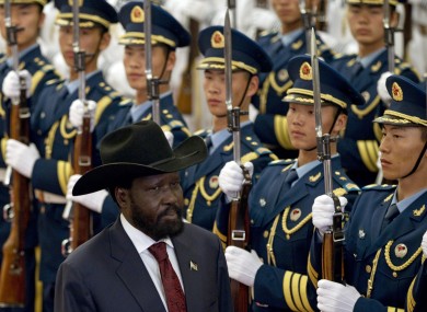 South Sudan president Salva Kiir reviews an honour guard in Beijing today