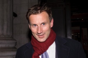 British Culture Secretary Jeremy Hunt leaves his office in London yesterday as the pressure mounted.