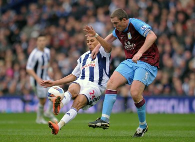 West Bromwich Albion's Peter Odemwingie is challenged by Aston Villa's Richard Dunne.