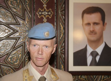 Maj Gen Robert Mood alongside a portrait of President Assad.