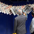 Greeks read newspapers hanging at a kiosk in Piraeus port, near Athens, on Tuesday, May 3, 2011.(AP Photo/Petros Giannakouris)