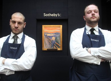 Sotheby's staff members stand guard over The Scream ahead of its auction earlier this month.
