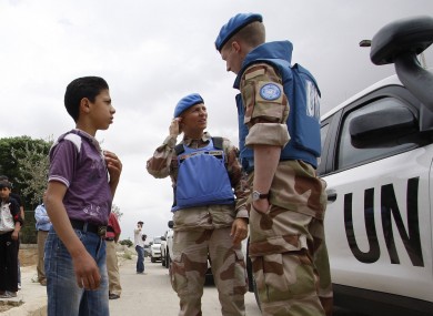 File photo: UN observers speak to a Syrian boy in Hama, 3 May 2012