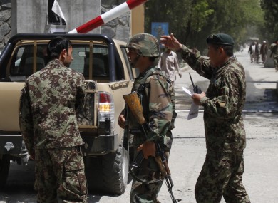Afghan National Army soldiers secure the gate of the military hospital after Arsala Rahmani, a former Taliban official turned Afghan peace negotiator, was killed by an unknown attacker.