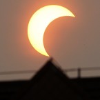 The eclipse over Beijing (AP Photo/Ng Han Guan)