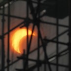 A partial solar eclipse is seen through construction scaffoldings in Beijing, China (AP Photo/Ng Han Guan)
