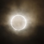 The moon slides across the sun, showing a blazing halo of light, during the annular eclipse at a waterfront park in Yokohama, near Tokyo  (AP Photo/Shuji Kajiyama)